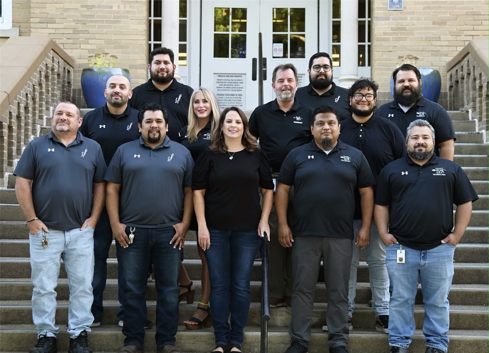 group of 12 adults wearing matching shirts